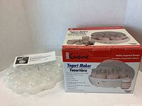 Photo showing Euro Cuisine yogurt maker box and clear plastic devilled egg holder next to it.