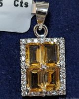 Close-up image of the pendant showing four rectangular citrine stones set in sterling silver, surrounded by small clear stones.