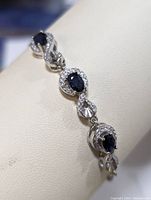 Close-up of sapphire and CZ stones in sterling silver setting