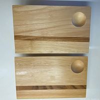 Two matching wooden boards shown from top view, highlighting the walnut inlay stripe and circular condensation indentation on each board's upper right corner.