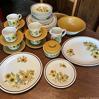 Full view of the MYOTT ironstone dinnerware set displayed on wooden table showing all items including plates, bowls, cups, saucers, creamer, sugar bowl, platter, and vegetable bowl.
