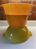 Side view of stacked bowls showing colors and handle shape