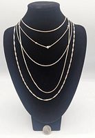 Five sterling silver chains displayed on black bust to show length and different chain styles.