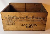 Front panel of wooden shipping crate showing Hudson's Bay Company logo, incorporation date, and Jamaica Rum text.