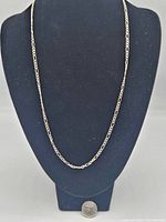 Sterling silver 20 inch chain necklace displayed on a black bust with a quarter for size reference.