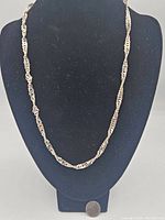 Full view of the silver fancy link chain necklace on display bust showing length and style
