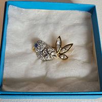 Swarovski bird brooch in box with white cushioned interior and blue exterior
