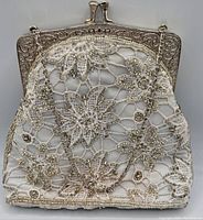 Front view of the vintage beaded purse showing the floral lace design and silver beading.