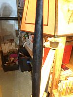 Close-up of the forged metal spike showing slight rust and dark patina.