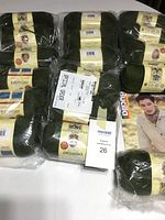 Lot of 11 skeins of Bucilla Everyday yarn in green color, packaged and tagged with MaxSold label.