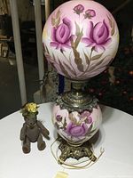 Full view of floral hand-painted Victorian style lamp next to teddy bear showing size comparison and detailed lamp base.