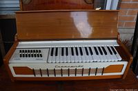 Front view of Crescendo electric organ showing keyboard, buttons, and front panel with brand name.