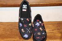 Top view of both slip-on shoes with Marvel villain-themed graphics and DC/Marvel logos.
