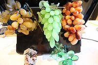 Overview of five grape clusters of varying colors and sizes displayed together