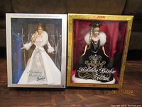Two boxed Barbie dolls side by side, Holiday Visions and Holiday Barbie 2006 editions