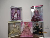 Overview of all five Mattel holiday Barbie dolls in original boxes showing different outfits and holiday themes.