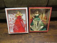 The two boxed Barbie dolls display side by side, showing their full outfits and packaging.