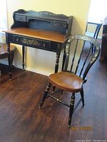 Photo showing full set of desk and chair, highlighting the black and maple finish with floral stencil decoration on both items.