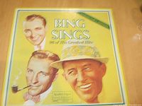 Front cover of the yellow collector's edition box featuring illustrated portraits of Bing Crosby and the title "Bing Sings" with 96 of his greatest hits.