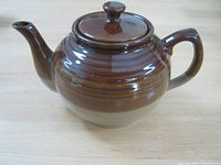 Full view of the Brown Betty teapot showing overall shape, handle, lid, and spout.