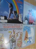 Photo of four children's music album covers arranged on a flat surface. Titles visible are Raffi "Baby Beluga," Roger Whittaker "The Magical World of...", Sharon, Lois & Bram "One Elephant, Deux Elephants", and The Rovers "Children of the Unicorn." Album covers measure approximately 12 inches by 12 inches.