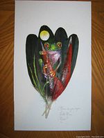 Front view of the novelty artwork, showing the full image of the frog painted on four feathers.