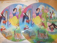 Both sides of the Disney Snow White and the Seven Dwarfs collectible picture disc LP showing colorful character artwork.