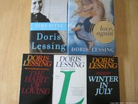 Five books arranged with two on top and three below. Shows hardcover 'Love, Again' and paperbacks 'Time Bites', 'The Habit of Loving', 'Martha Quest', and 'Winter in July'.