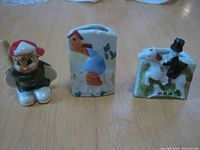 Front view of three vintage Occupied Japan ceramic items including a small figure and two small painted vases