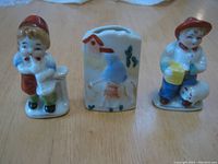 Front view of three porcelain figures and vase showing detailed painting and size