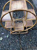 Top view showing the circular bamboo frame and the three rectangular wicker shelves inside.