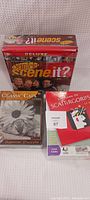 Photo showing Seinfeld Scene It? Deluxe DVD board game, Scattergories card game, and Classic Cats puzzle
