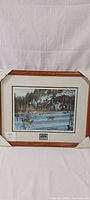 Full view of framed Paul Rankin wildlife art print 'Family Pursuit' depicting wolves in a snowy landscape.