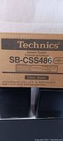 Box showing Technics branding and model SB-CSS486 speaker system, color black, manufactured by Matsushita Electric Industrial Co. Ltd in Puerto Rico.