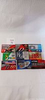 Photo showing various unused video and audio tapes including Maxell UR 60, Fuji 8mm videocassette, TDK D60, Philips VHS-C HP60, Memorex 60 min, TDK HG and A60 audio cassette tapes
