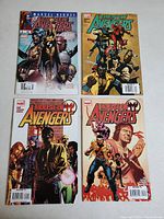 Photo of 4 Marvel Avengers comics: two The New Avengers and two House of M Avengers, covers visible showing characters and logos.