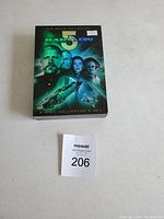 Photo of Babylon 5 The Movie Collection box set showcasing the box art with characters and spaceships with a label shown in front.