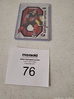 Front of Claude Giroux Tim Hortons hockey card featuring player in red and black hockey uniform.