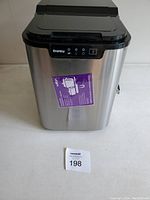 Front and top view of Danby DIM2500SSDB portable ice maker stainless steel body with control panel and sticker.