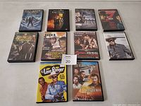Photo of 10 Western DVDs arranged in two rows on a plain surface showing distinct cover art.