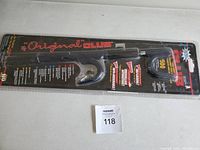 Full view of Original Club brand steering wheel lock in sealed packaging with clear plastic cover and cardboard backing.