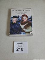 Photo of The Snoop Sisters DVD set showing the front cover with two elderly women and auction lot number.
