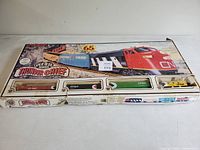 Closed box containing the Bachmann Thunder Chief train set with visible locomotive and freight cars in window compartments.