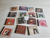 Photo capturing all 15 CDs laid out flat showing front covers with various artists and genres.