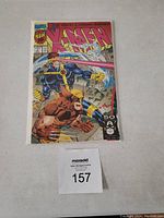 Front cover of the 1st issue X-Men comic book showing Cyclops and Wolverine in action.