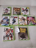 Nine Xbox 360 game cases arranged in three rows showing various sports and action titles.