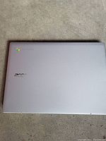 Closed Acer Chromebook laptop showing silver top lid with Acer and Chrome logos.