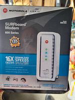 Photo of the Motorola ARRIS SURFboard 600 Series modem box showing model number SBG6183 with key features such as DOCSIS 3.0, speeds up to 686 Mbps, and energy efficiency.