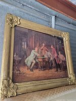 Framed oil painting showing five men in 18th century style dress in a detailed interior scene with decorative gold frame.