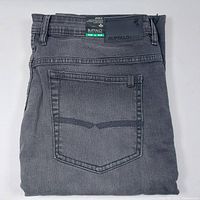 Folded view of men's slim straight stretch denim jeans in black/grey with back pocket and leather brand patch.